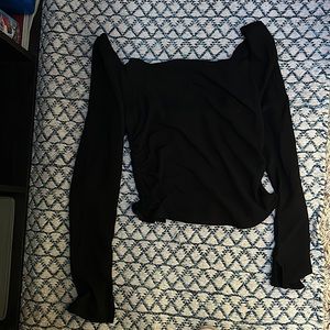 Black long sleeve blouse, ruched back, and a slit sleeve.